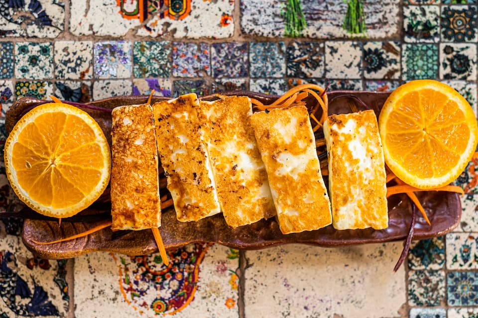 Popular Street Food, Grilled Cheese on a plate with herbs top - Chef's Deal